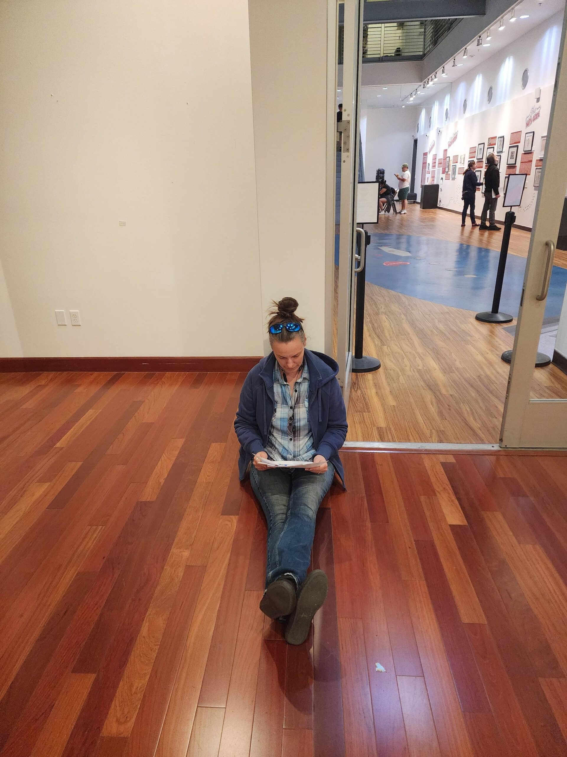 Karen sits on the floor of the Museum to write notes.