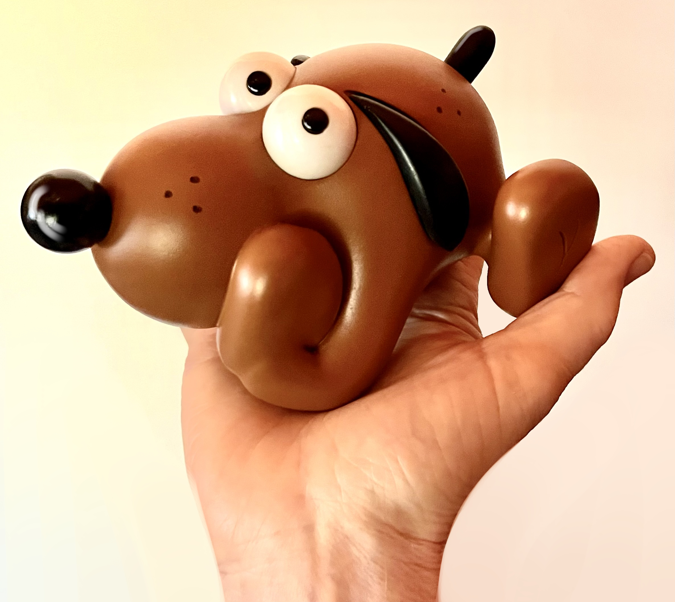 Puddles figurine held in a hand and looking sidewise.