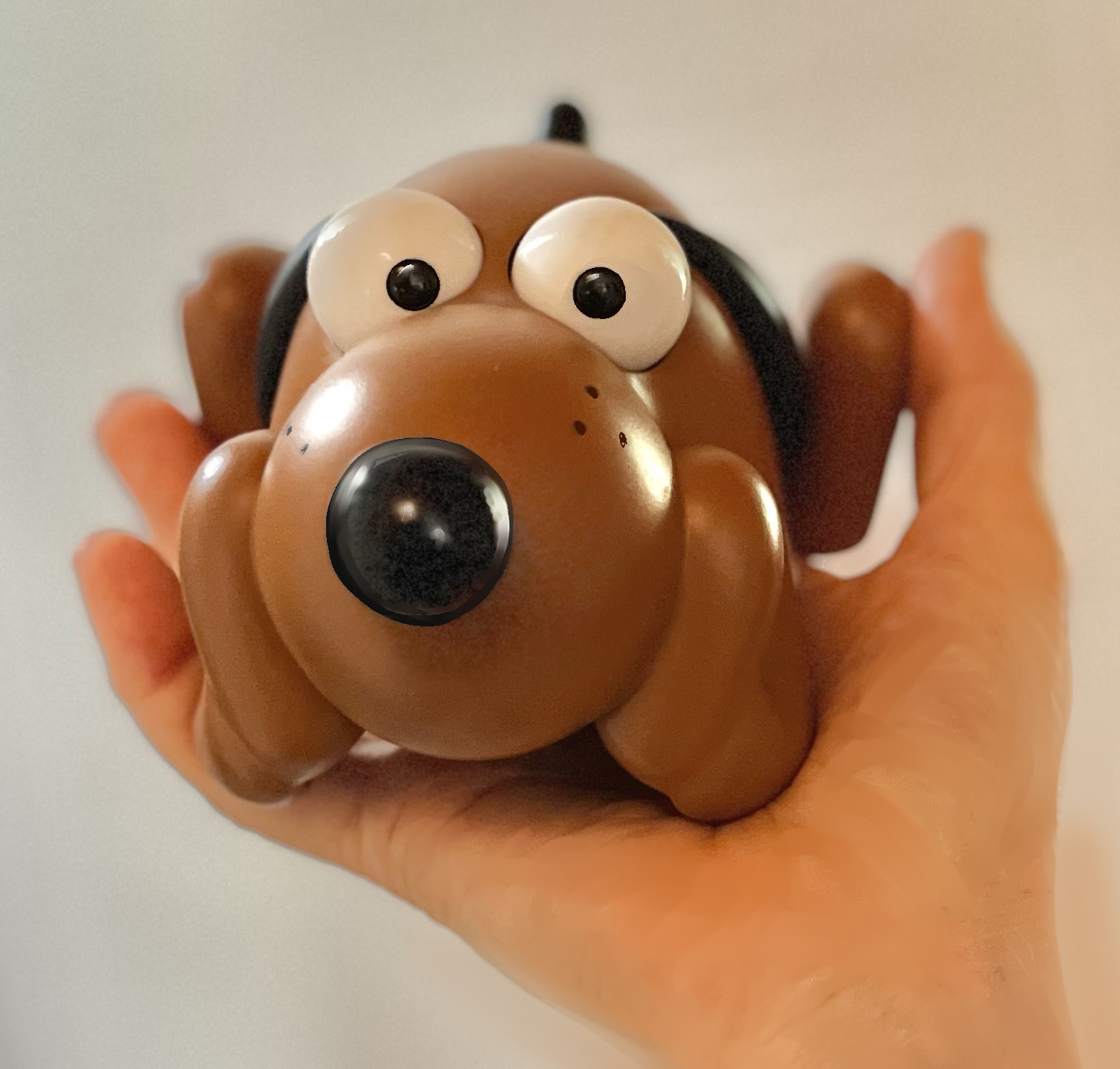 Puddles figurine held in a hand, looking forward